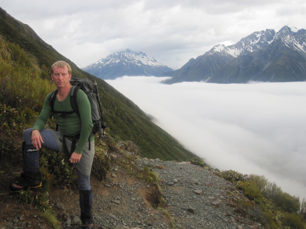 David Ellacott on the way up Mt Wakefield.  The Tasman valley below him hidden under early morning cloud.