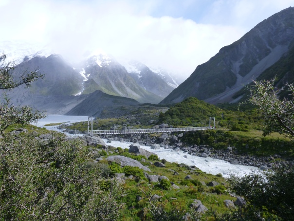 Walking up the beautiful Hooker Valley track, with one of the large new swing bridges visible in photo centre.