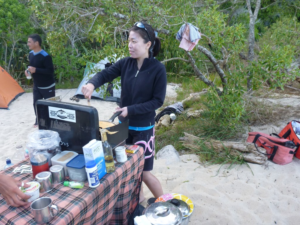 Stephanie cooks dinner at the campsite.