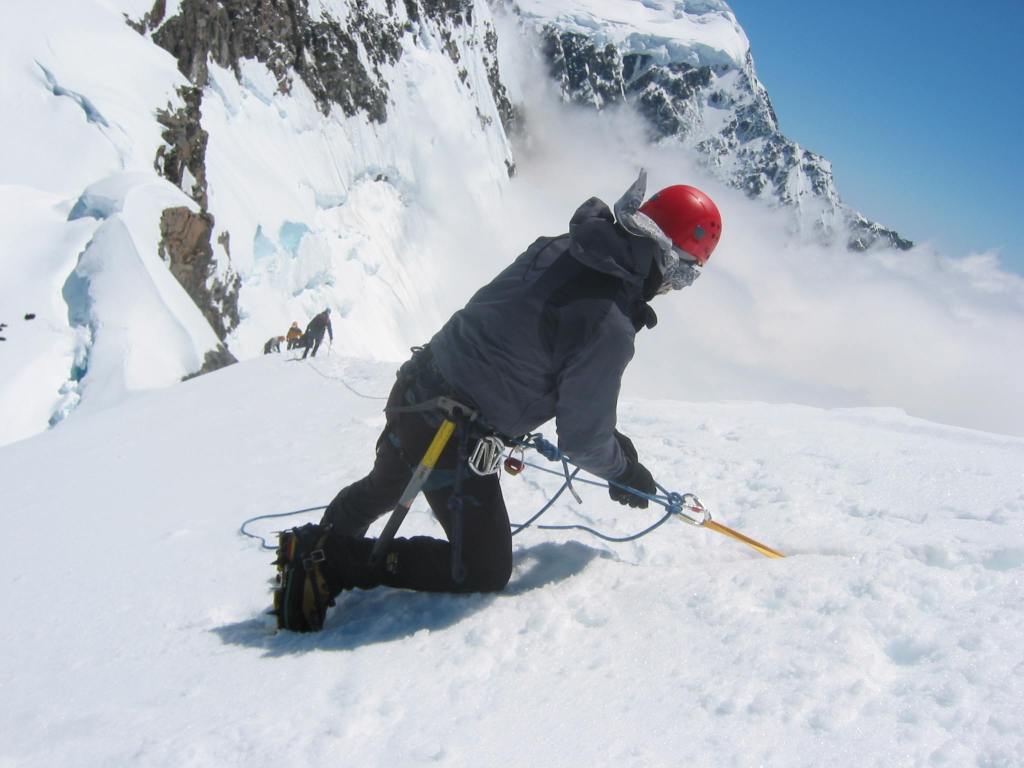 Setting up a belay using a T-slot in the snow on Mt Alymer