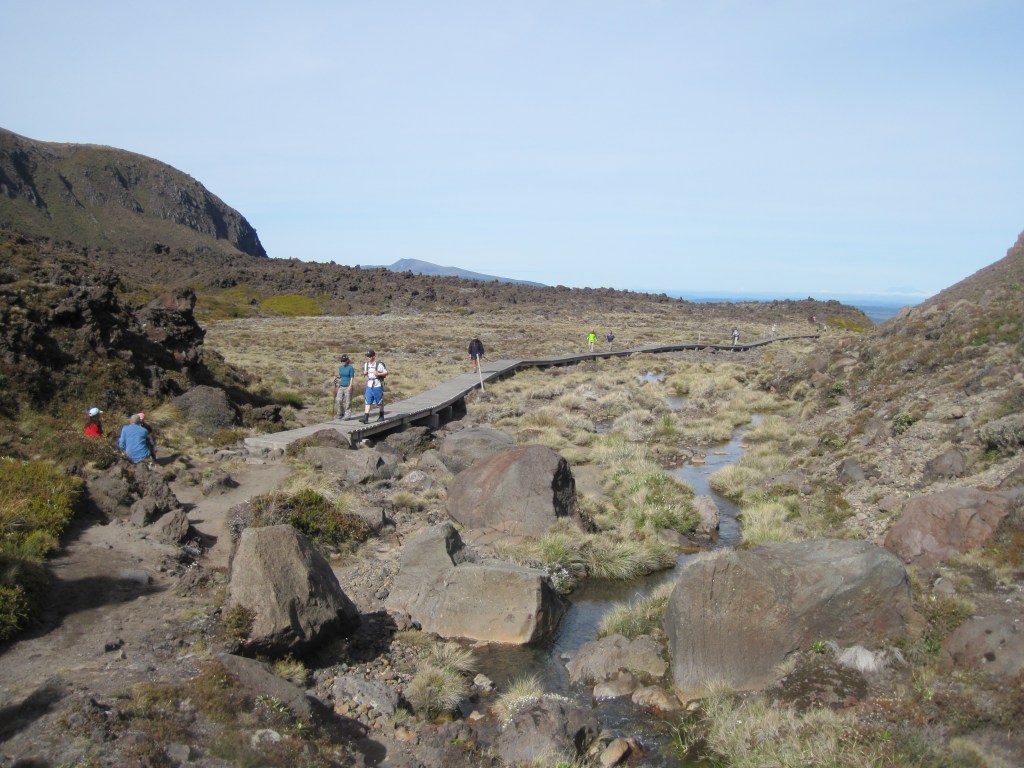 Walking along the board walks up into the red crater