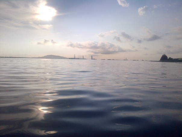 Beautiful flat conditions initially as the sun rises and we head towards Changi finger. The land visible on the left of the photo is the South Eastern coast of Malaysia.