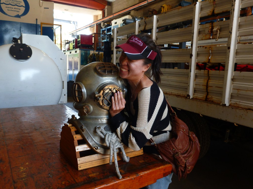 Stephanie trying out an old diving helmet in the Marine Diving Technology facility in Santa Barbara.