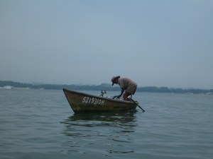 This guy was fishing for crabs from his boat.
