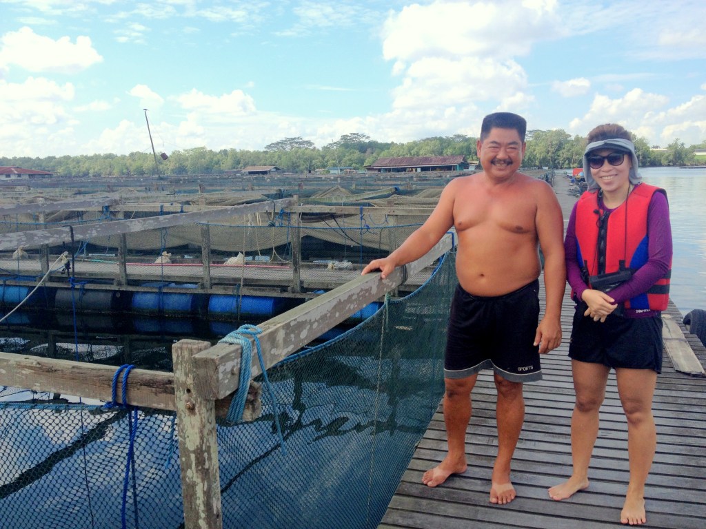 Stephanie and Mr Ang on a tour of his farm.