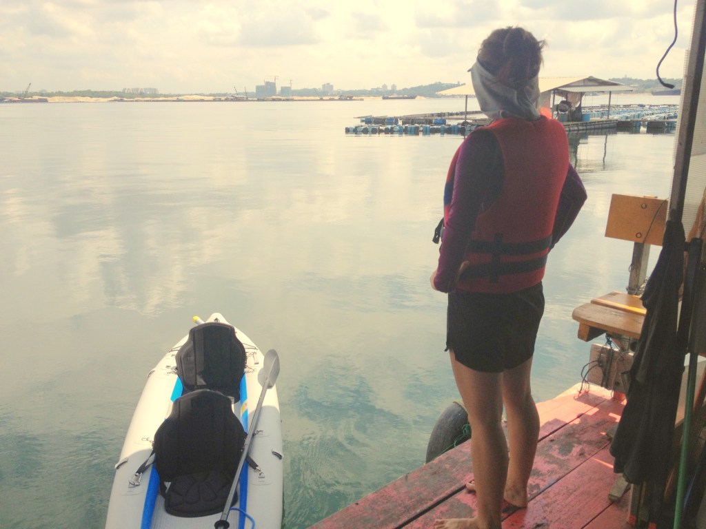 Stephanie standing on Mr Ang's kelong - that's Danga Bay - a new condo development in Johor out in the distance.