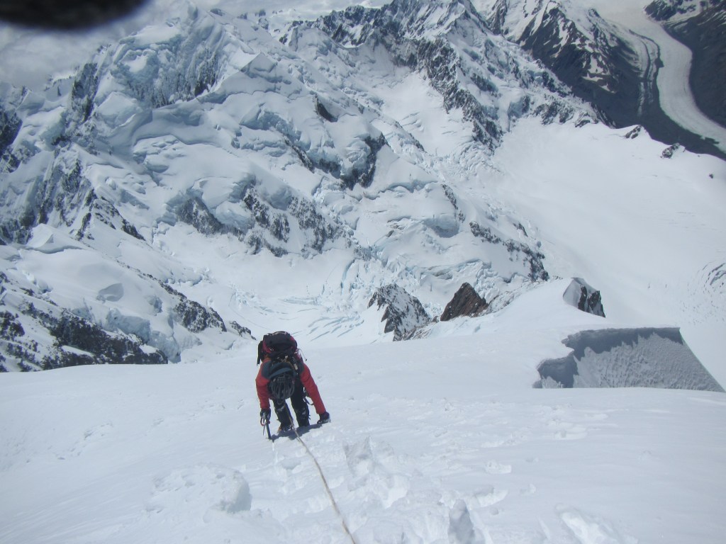 Alan Silva carefully down climbing from the summit of Mt Cook.