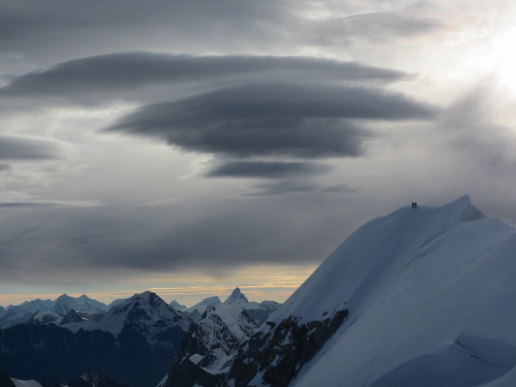 As the sun comes up - two climbers visible on the ridge of Mt Maudit